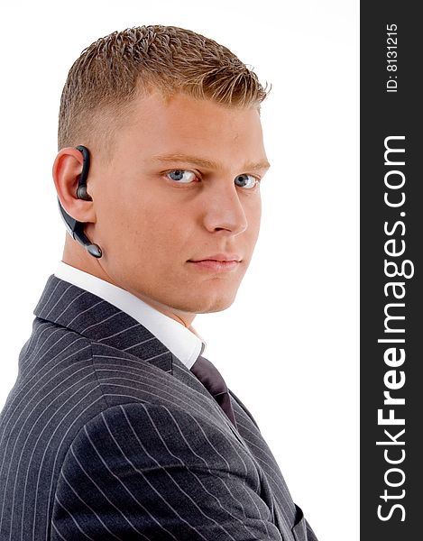 Serious businessman posing with bluetooth on an isolated white background. Serious businessman posing with bluetooth on an isolated white background