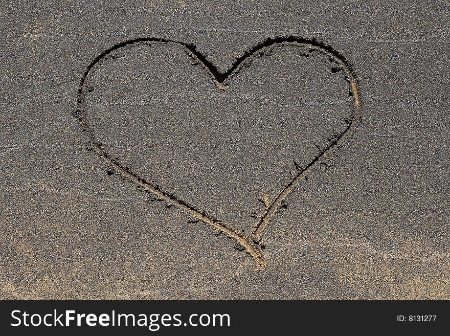 Heart symbol drawn in the black sand beach. Heart symbol drawn in the black sand beach.