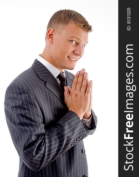 Smiling praying businessman on an isolated background