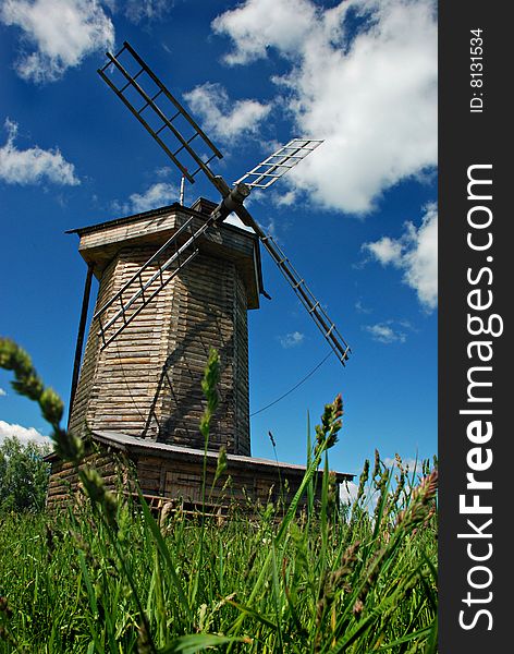 Windmill in field, rural summer landscape, museum of old wooden architecture, Suzdal, Russia