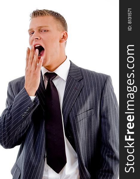 Yawning young businessman against white background