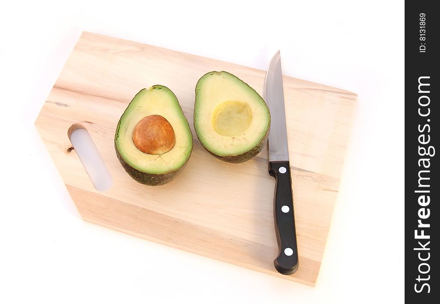 Avocado cut in half with pit isolated over white. Avocado cut in half with pit isolated over white