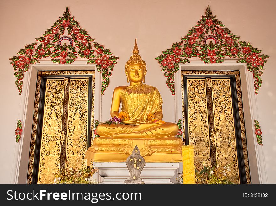 Buddha image with two Thai style gold doors of church in Thai temple. Buddha image with two Thai style gold doors of church in Thai temple.