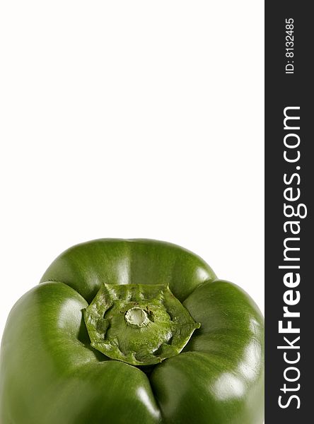 Top half of green bell pepper on white with plenty of copy space. Vertical orientation. Focus on top center of pepper.