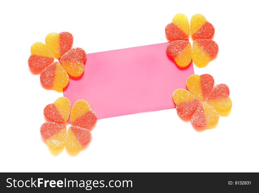 Congratulatory card with yellow-red fruit candy in the form of hearts