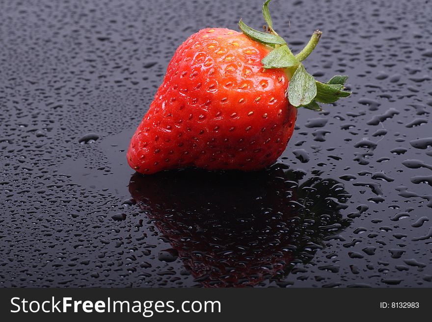 Fresh ripe strawberries isolated on the dark background.