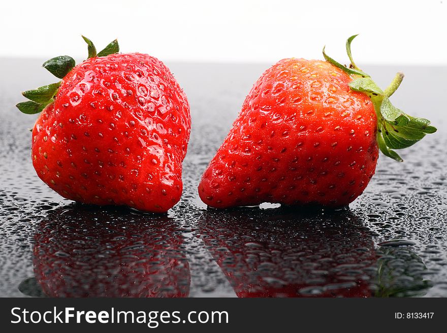 Fresh ripe strawberries isolated on the dark background.
