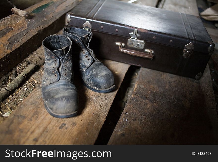 Stock photo: an image of old black boots an a black valise. Stock photo: an image of old black boots an a black valise
