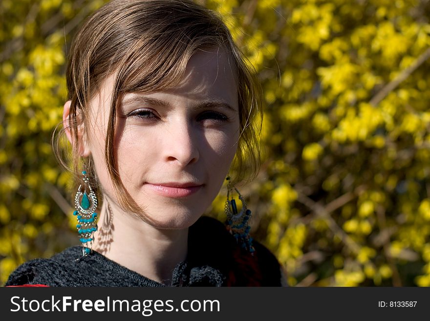 Beautiful women portrait with blue earings and flower background. Beautiful women portrait with blue earings and flower background