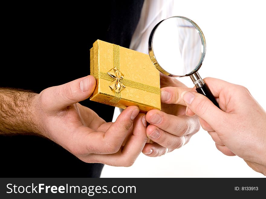 Stock photo: an image of a yellow box in hands of a man and magnifier