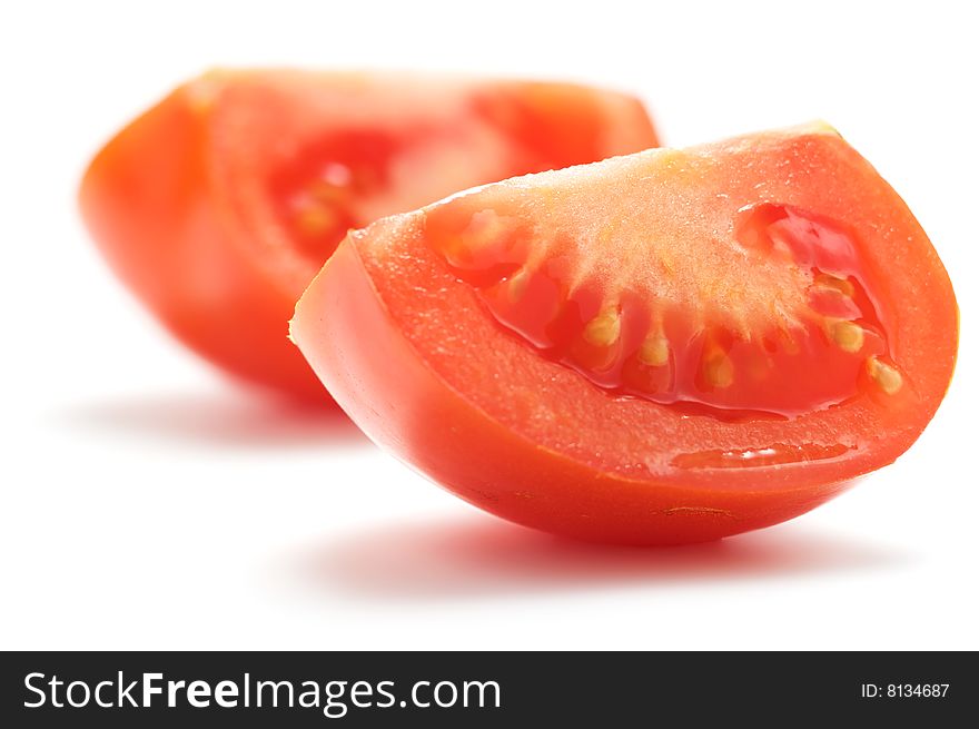 A piece of tomato isolated on a white background. Background blurry.