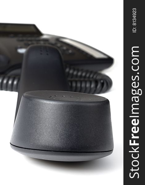 Modern black business office telephone with the receiver off the hook isolated on a white background. Modern black business office telephone with the receiver off the hook isolated on a white background