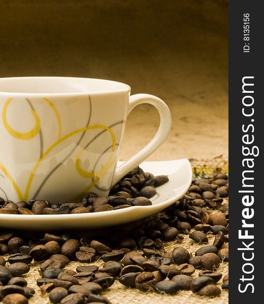Coffee cup on coffee grains