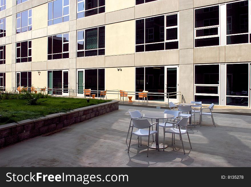 A modern loft courtyard with tables and chairs