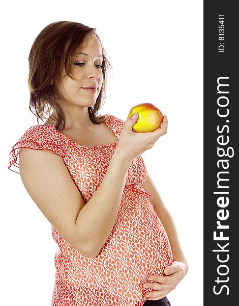 Studio photo of beauty pregnant woman with apple