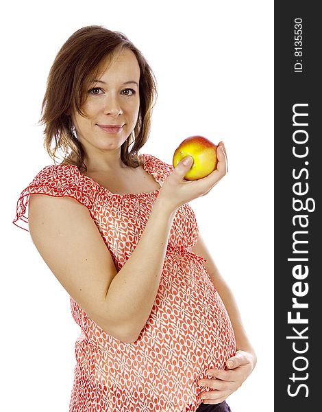 Studio photo of beauty pregnant woman with apple