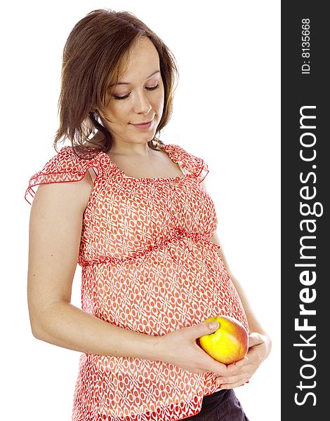 Studio photo of beauty pregnant woman with apple