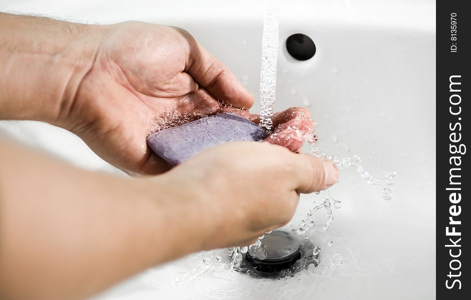 Hands of a person being washed under a tap. Hygiene is important. Hands of a person being washed under a tap. Hygiene is important.