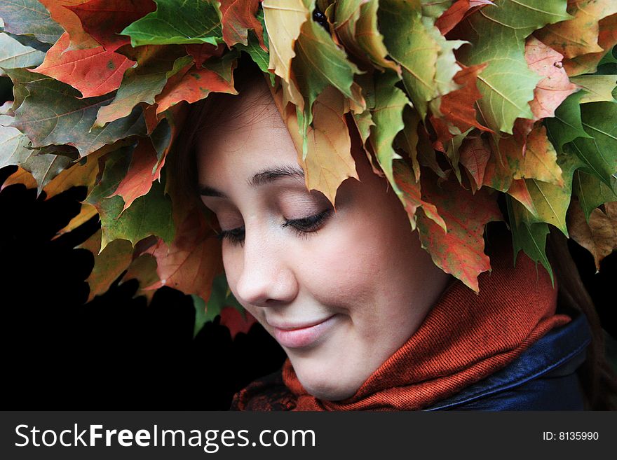 Girl has yellow and green leaves at the head. Girl has yellow and green leaves at the head