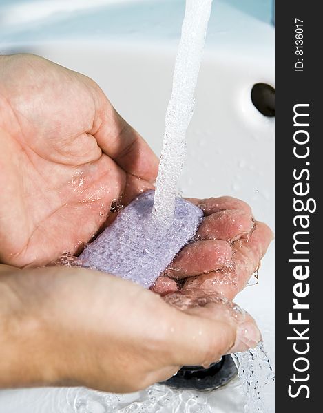 Hands of a person being washed under a tap. Hygiene is important. Hands of a person being washed under a tap. Hygiene is important.