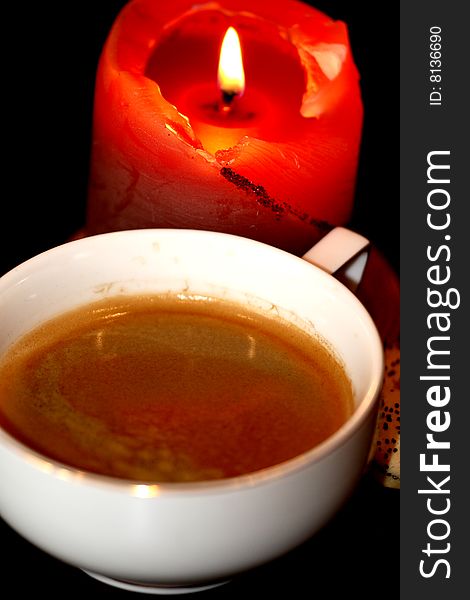 Cup coffee and candle in the dark