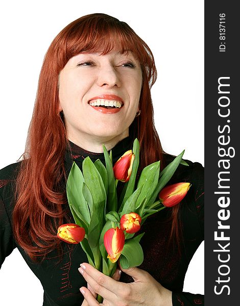 The joyful woman holds in hands a bouquet from tulips. The joyful woman holds in hands a bouquet from tulips