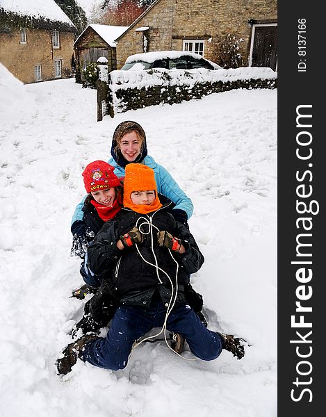 Children on a toboggan in the snow. Children on a toboggan in the snow