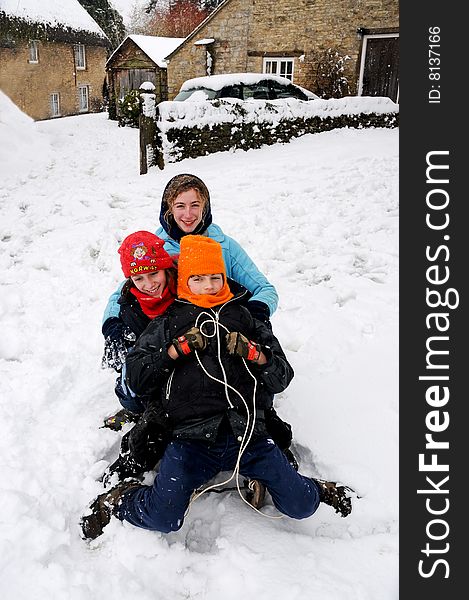 Kids tobogganing in the snow