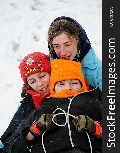 Closeup portrait of children on toboggan in the snow