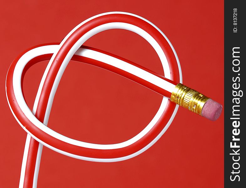 Pencil heart on red background