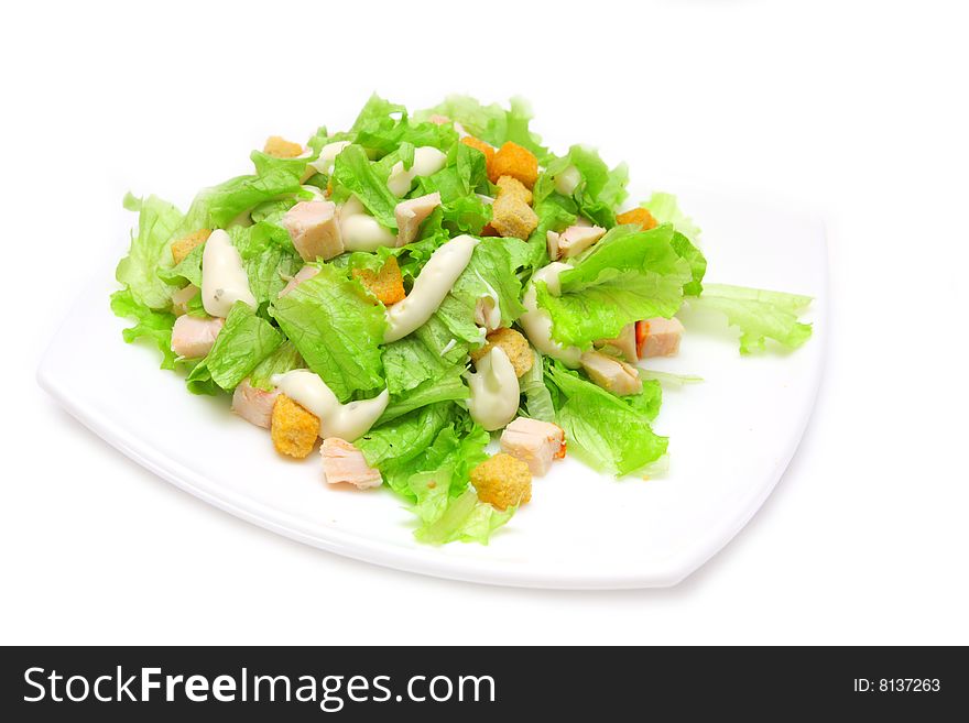 Caesar salad with chicken on white background