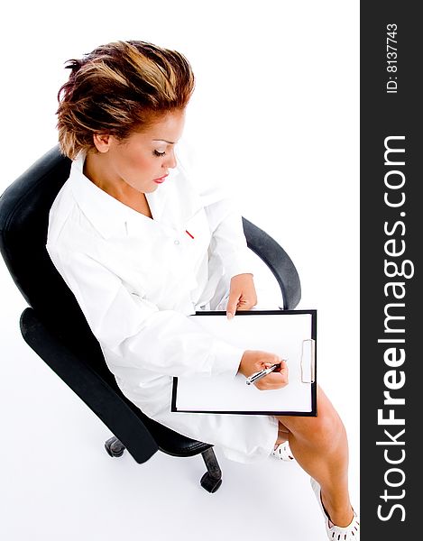 Female doctor writing on notepad on an isolated white background