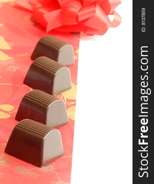 Chocolate Candy With Red Ornament Isolated On A Wh