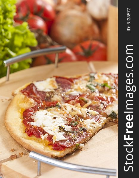 Oven baked pizza served on wooden board with shallow DOF
