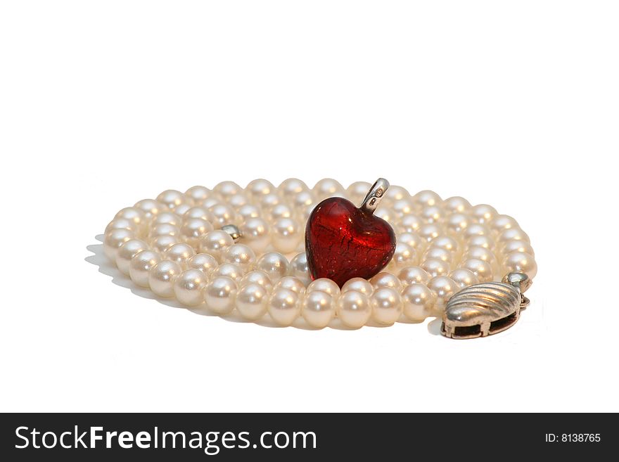 Red heart in the pearl necklace isolated on white background. Red heart in the pearl necklace isolated on white background