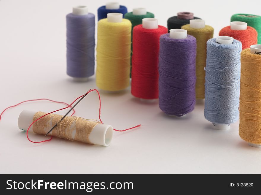 Reels of sewing threads of different colors for embroidery