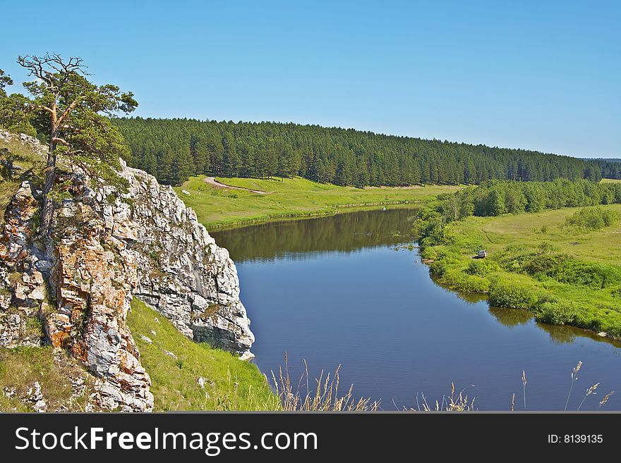 Beautiful rural landscape with a tree and small river