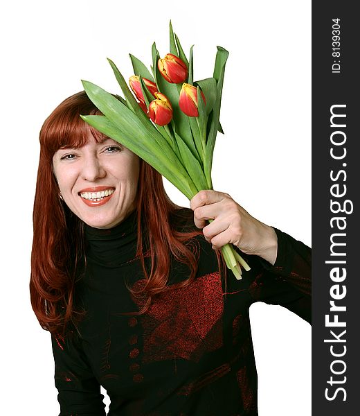 The joyful woman holds in hands a bouquet from tulips. The joyful woman holds in hands a bouquet from tulips