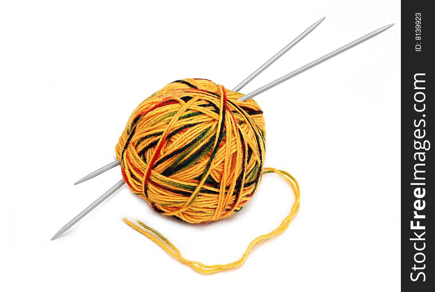 Yellow wool ball with needles isolated over white