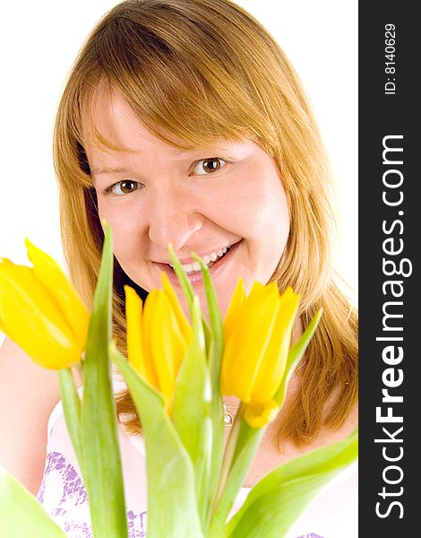 Attractive young woman with yellow tulips