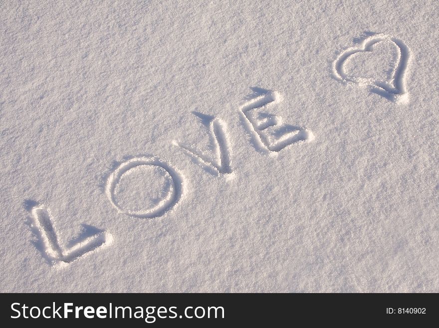 Writing text  LOVE   on the snow