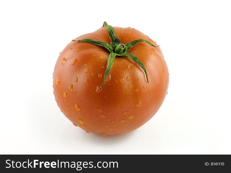 Tomato in water droplets on white backgound