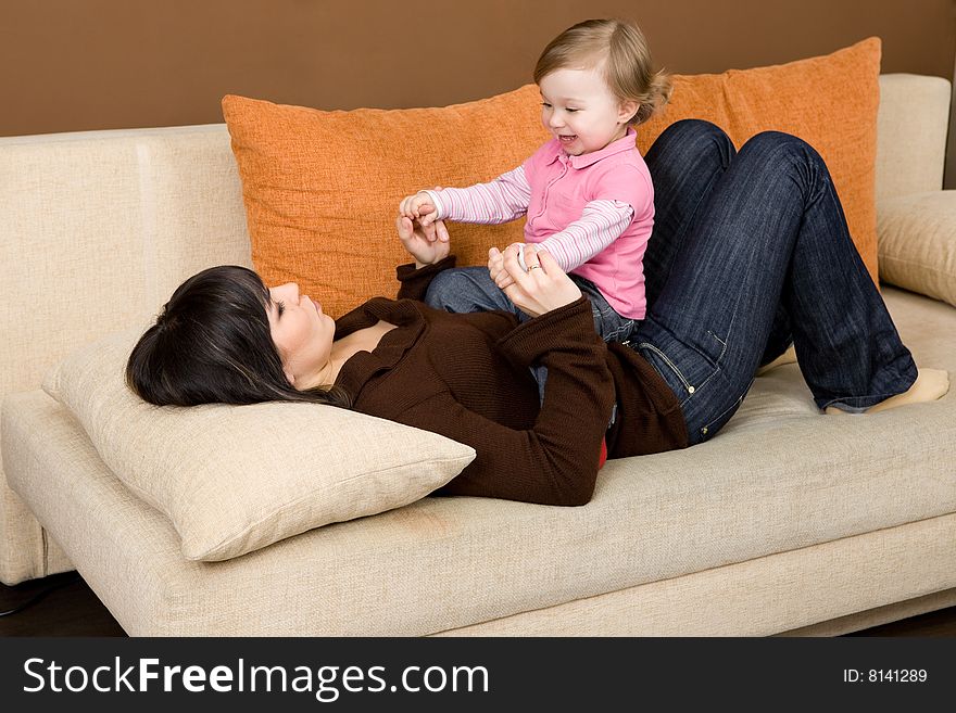 Happy family playing on sofa. Happy family playing on sofa
