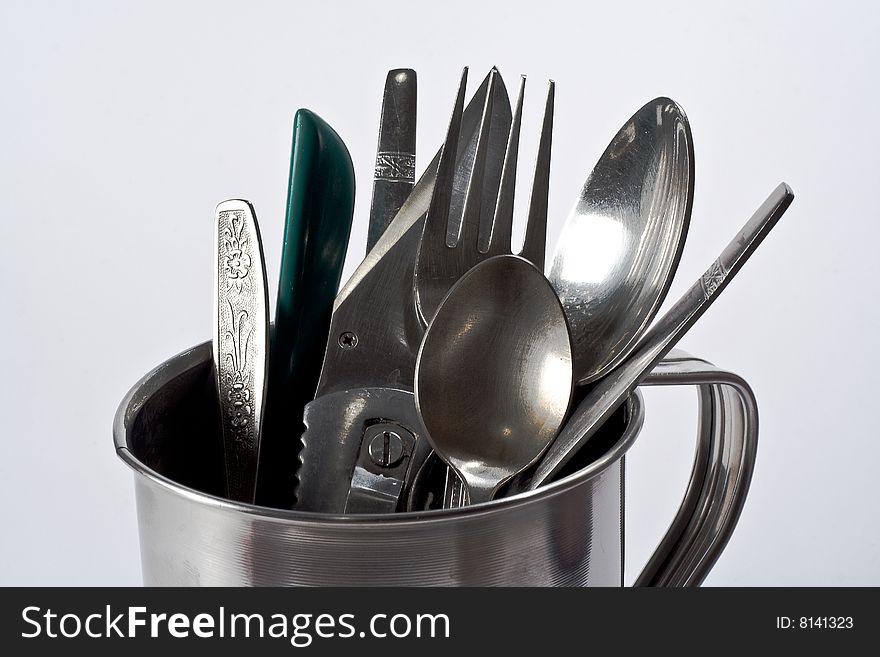 Cutlery in a silver mug.