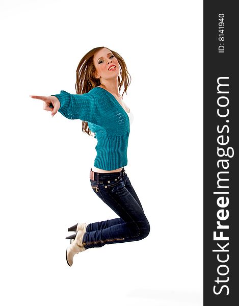 Side view of young female jumping with white background