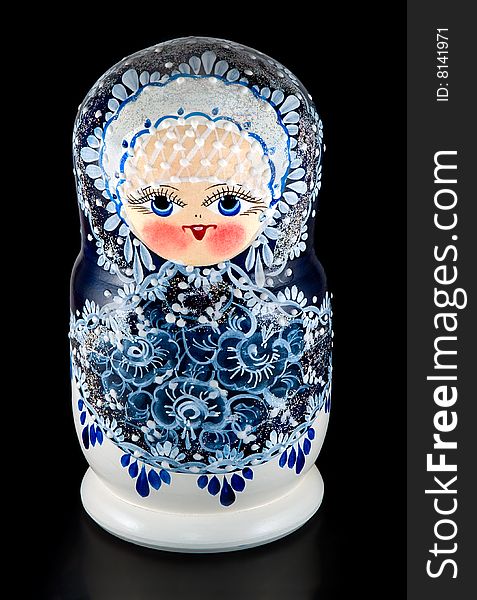 The Russian nested doll is photographed on black