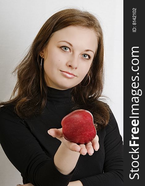 Attractive woman holding red apple