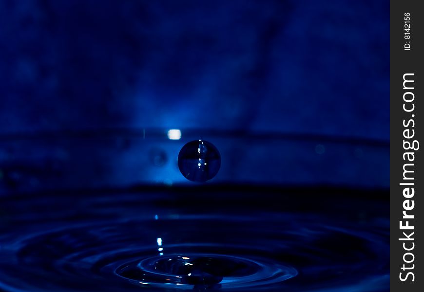 Water drop on dark blue background