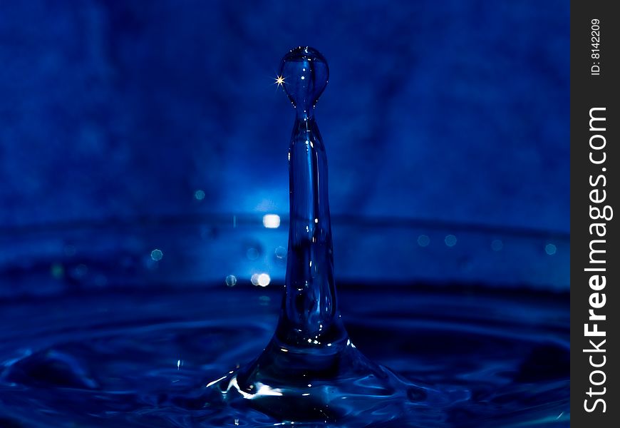 Water drop on dark blue background