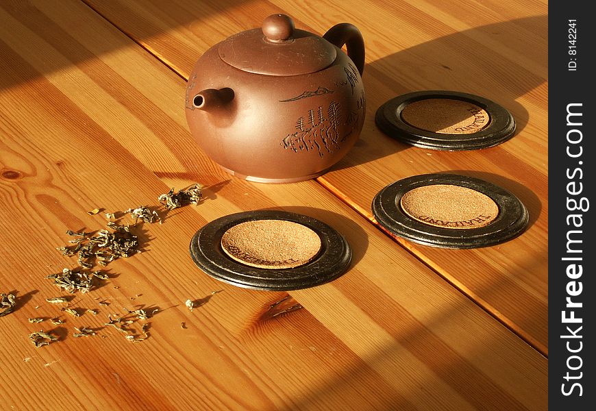 Tea in the teapot on the wooden table sunnely morning